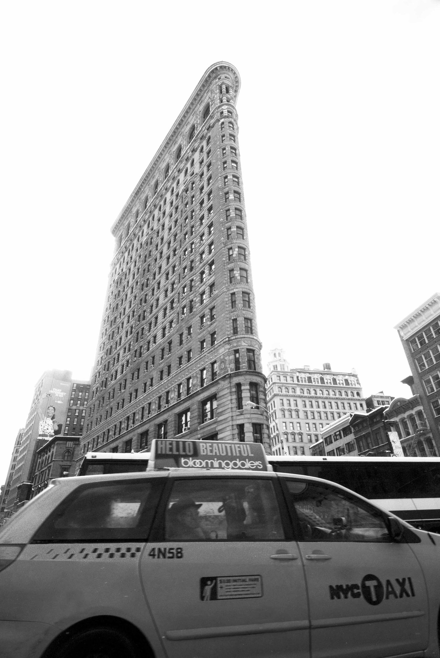 The Flatiron Building on New Yorks 5th Avenue features in this busy street scene.